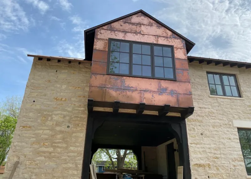 Copper metal panel facade on a stone building for Skylight Installation in Arlington