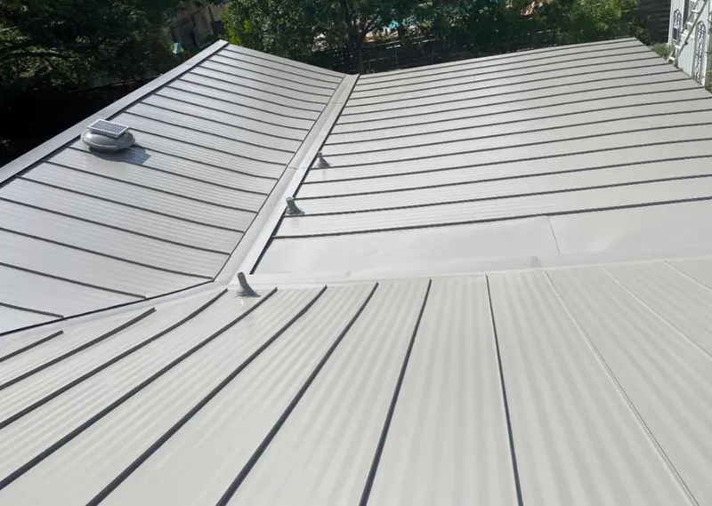 Solar attic fan installed on a metal roof for Roof Ventilation in Arlington